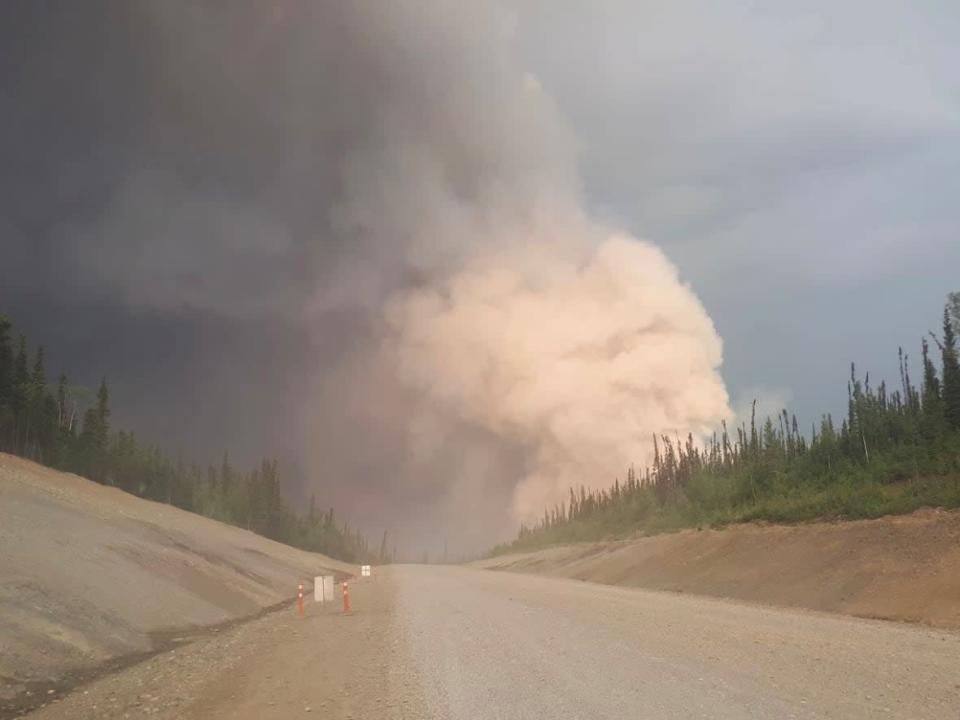 A photo of the Crystal Creek fire taken by a driver on the Klondike Highway. The Yukon Protective Services said the highway remains open right now, but urge drivers to monitor Yukon 511 for updates on the situation.  (Yukon Protective Services/ Facebook - image credit)