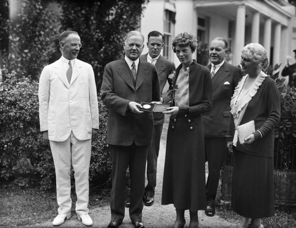 <div class="inline-image__caption"><p>President Herbert Hoover presenting the National Geographic Society gold medal to Amelia Earhart in recognition of her continuous solo flight across the Atlantic.</p></div> <div class="inline-image__credit">Bettmann/Getty</div>