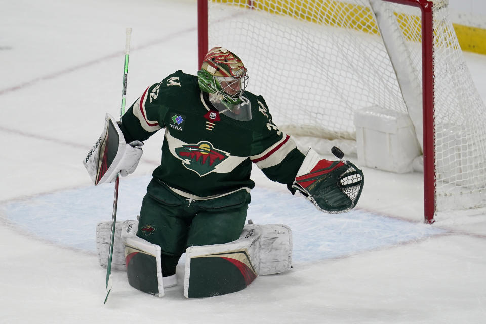 Minnesota Wild goaltender Filip Gustavsson blocks a shot during overtime of an NHL hockey game against the New York Islanders, Tuesday, Feb. 28, 2023, in St. Paul, Minn. (AP Photo/Abbie Parr)