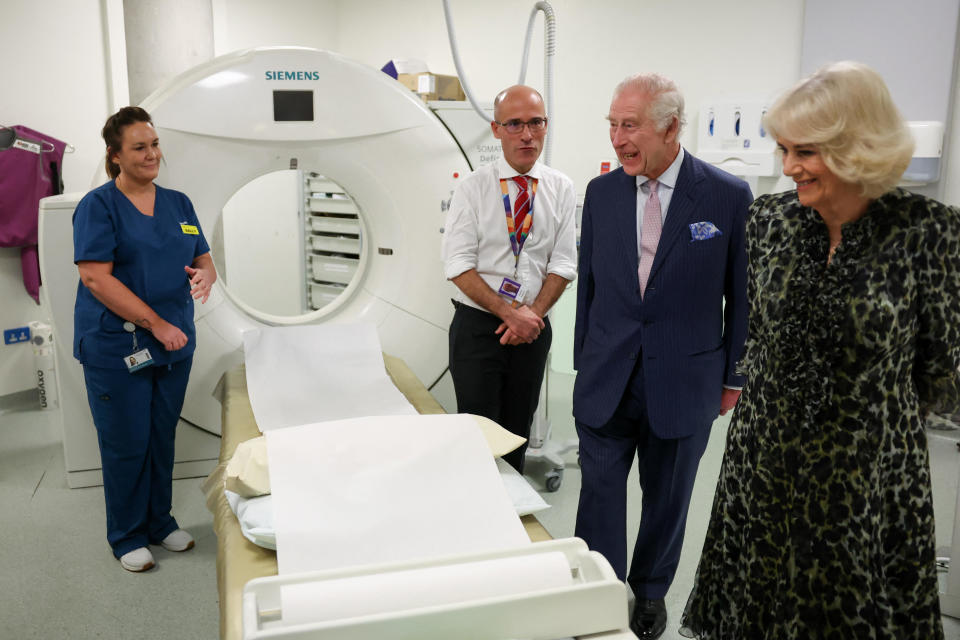 King Charles III and Queen Camilla look at the CT scanner next to Cancer Research U.K.'s Chief Clinician, Charlie Swanton, during a visit to the University College Hospital Macmillan Cancer Centre, April 30, 2024 in London, England. / Credit: Suzanne Plunkett - WPA Pool/Getty