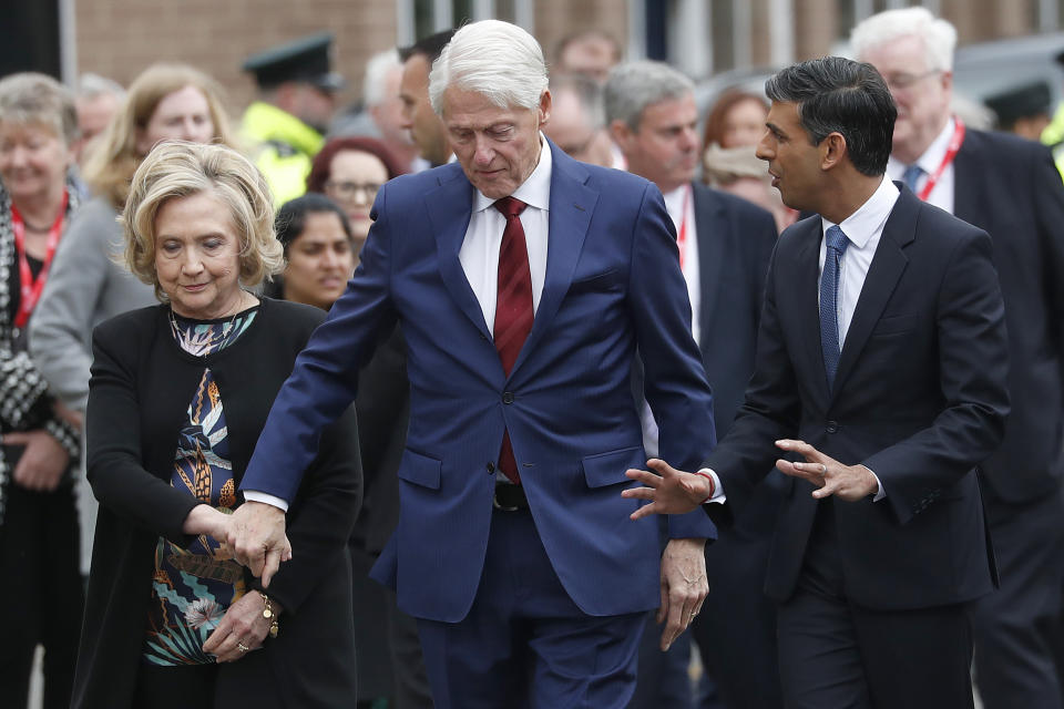 Britain's Prime Minister Rishi Sunak, former US president Bill Clinton and former US secretary of state Hillary Clinton chat as they walk to the Queen's University Belfast in Belfast, Wednesday, April 19, 2023 during the international conference to mark the 25th anniversary of the Belfast/Good Friday Agreement. (AP Photo/Peter Morrison)