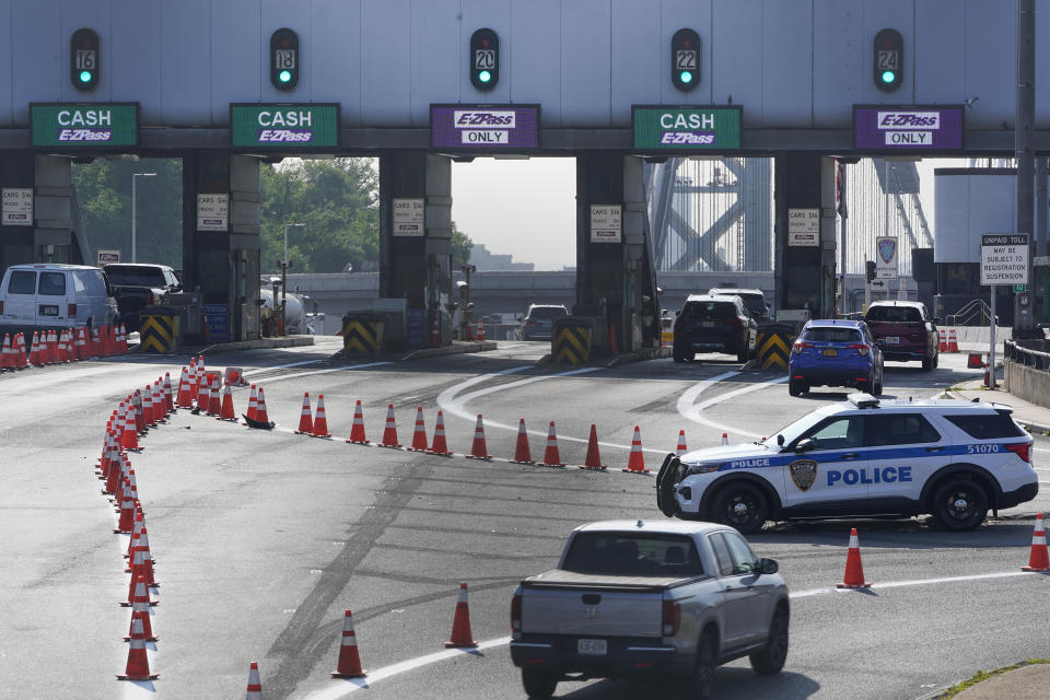 Cars pass through toll booths to use the George Washington Bridge in Fort Lee, N.J., Friday, July 8, 2022. The busy bridge connecting New Jersey and New York City is moving to cashless tolls. Beginning July 10, drivers paying cash tolls will have their license plates scanned and will be billed by mail. (AP Photo/Seth Wenig)