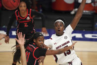 South Carolina forward Laeticia Amihere (15) looks for a pass against Georgia guard Maya Caldwell (11) during the first half of an NCAA college basketball game Sunday, March 7, 2021, during the Southeastern Conference tournament final in Greenville, S.C. (AP Photo/Sean Rayford)