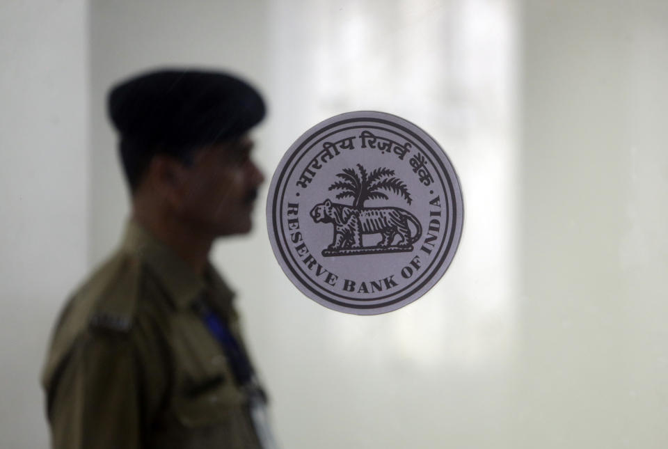 An Indian security guard stands at the gate of the Reserve Bank of India in Mumbai, India, Thursday, June 6, 2019. India's central bank has cut its key interest rate by a quarter of a percentage point to 5.75% from 6% with immediate effect to fortify the economy as consumer spending and corporate investment falter. (AP Photo/Rajanish Kakade)