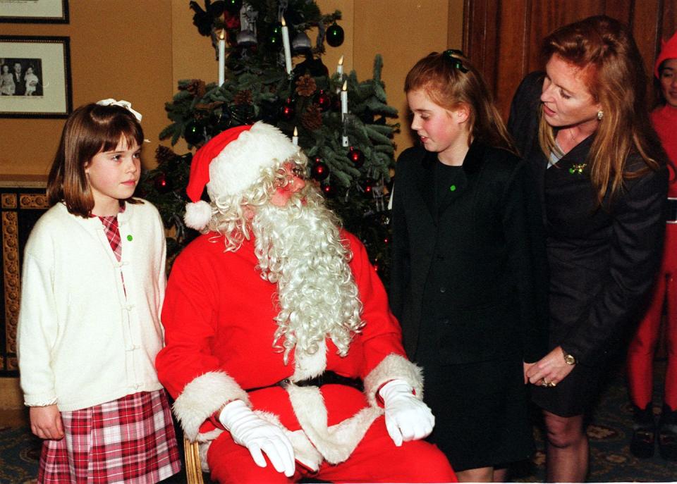 <p>The Duchess of York takes her daughters, Princess Eugenie and Princess Beatrice, to meet Santa at the National Society for the Prevention of Cruelty to Children party.</p>