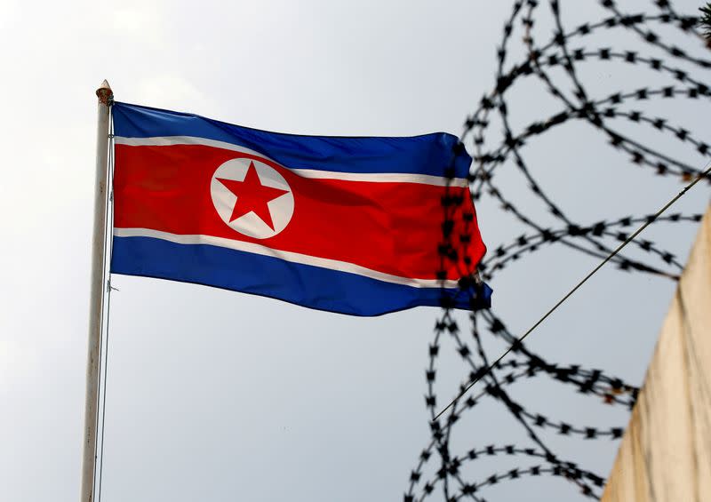 FILE PHOTO: A North Korea flag flutters next to concertina wire at the North Korean embassy in Kuala Lumpur