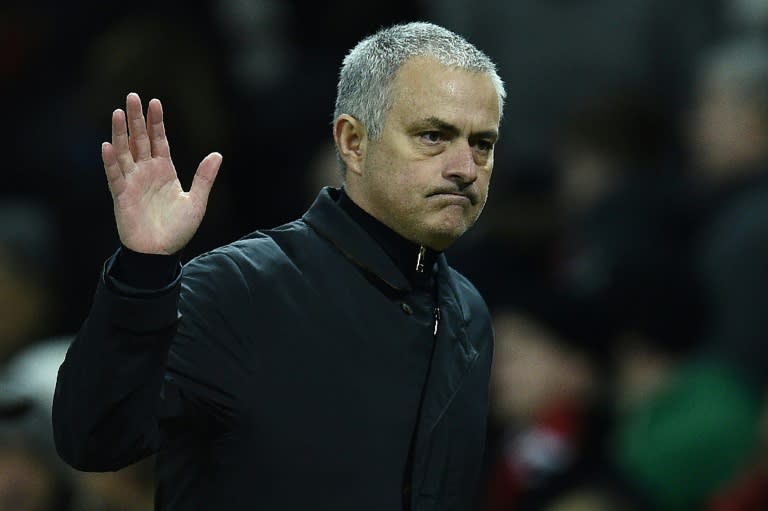 Manchester United's Portuguese manager Jose Mourinho waves to the fans following the UEFA Europa League Round of 32 first-leg football match against Saint-Etienne on February 16, 2017
