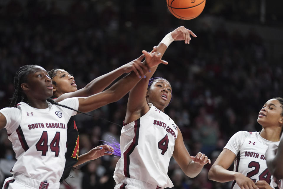 South Carolina forward Aliyah Boston (4), Saniya Rivers (44), and LeLe Grissett (24) battle for a rebound against Maryland forward Angel Reese (10) during the first half of an NCAA college basketball game Sunday, Dec. 12, 2021, in Columbia, S.C. (AP Photo/Sean Rayford)