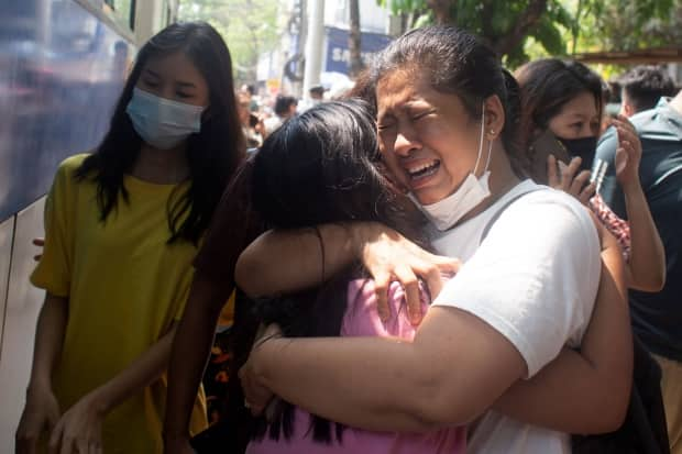 Protesters detained by police during an anti-coup demonstrations react after being released at Tamwe township police station in Yangon, Myanmar, on March 24, 2021.  (Reuters - image credit)