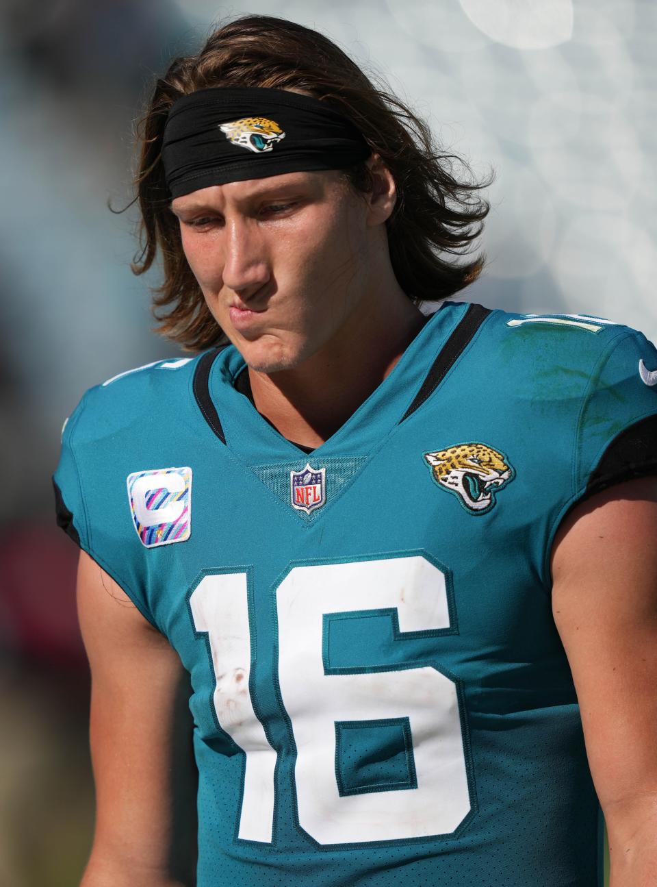 Trevor Lawrence walks off the field after Sunday's defeat against the Titans.