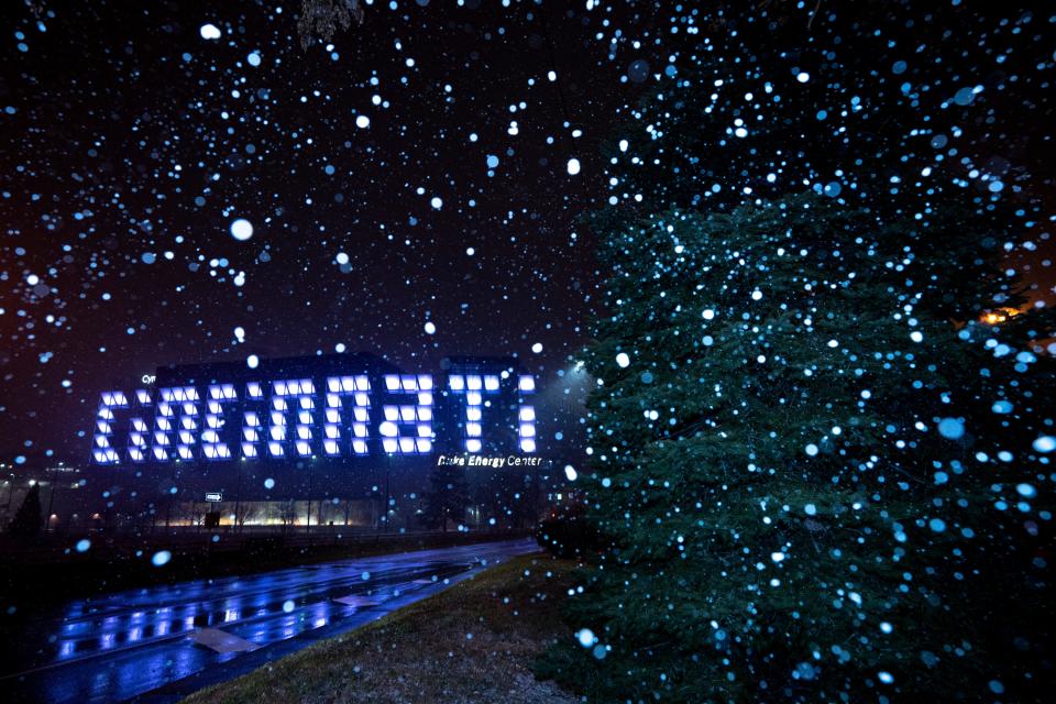 Snow falls in front of the Duke Energy Center sign in Cincinnati on Thursday, Dec. 22, 2022. A winter storm warning went into effect for the area starting at 7 p.m. Thursday and will last through 5 p.m. Friday.