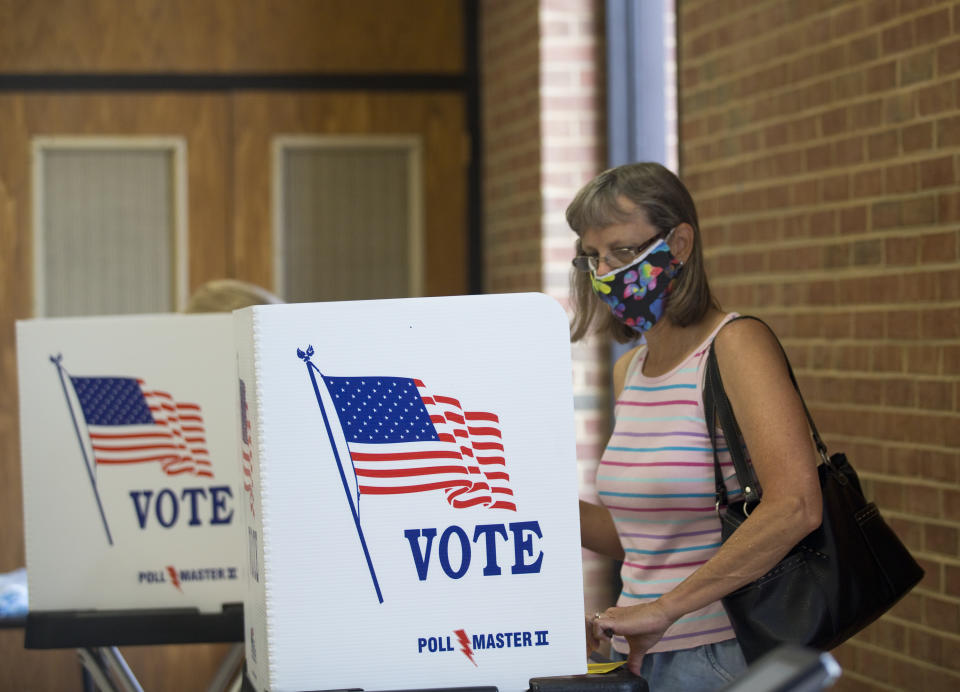Susan Burr casts her votes during the Republican candidates primary election, Tuesday, June 23, 2020, at Hidden Valley Middle School in Roanoke, Va. (Stephanie Klein-Davis/The Roanoke Times via AP)