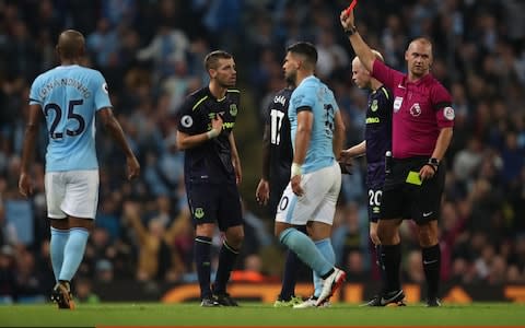 Morgan Schneiderlin of Everton receives a red card following a challenge on Sergio Aguero - Credit: Getty