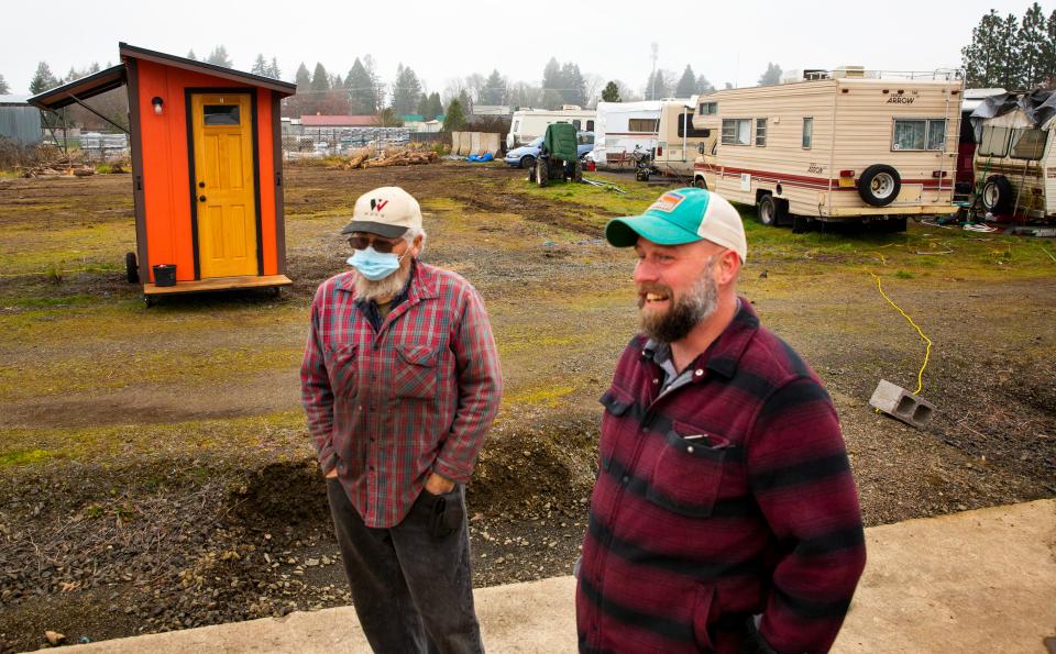 Resident Sam Jones, left and Everyone Village co-founder Gabe Piechowicz talk about the new Safe Sleep site in Eugene.