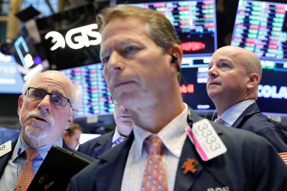 Traders work on the floor at the New York Stock Exchange (NYSE) in New York, U.S., October 24, 2019. REUTERS/Brendan McDermid