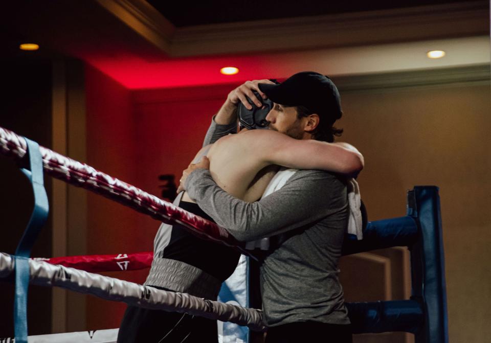 Peoria native and Air Force Academy boxing head coach Blake Baldi embraces one of his fighters after a bout.