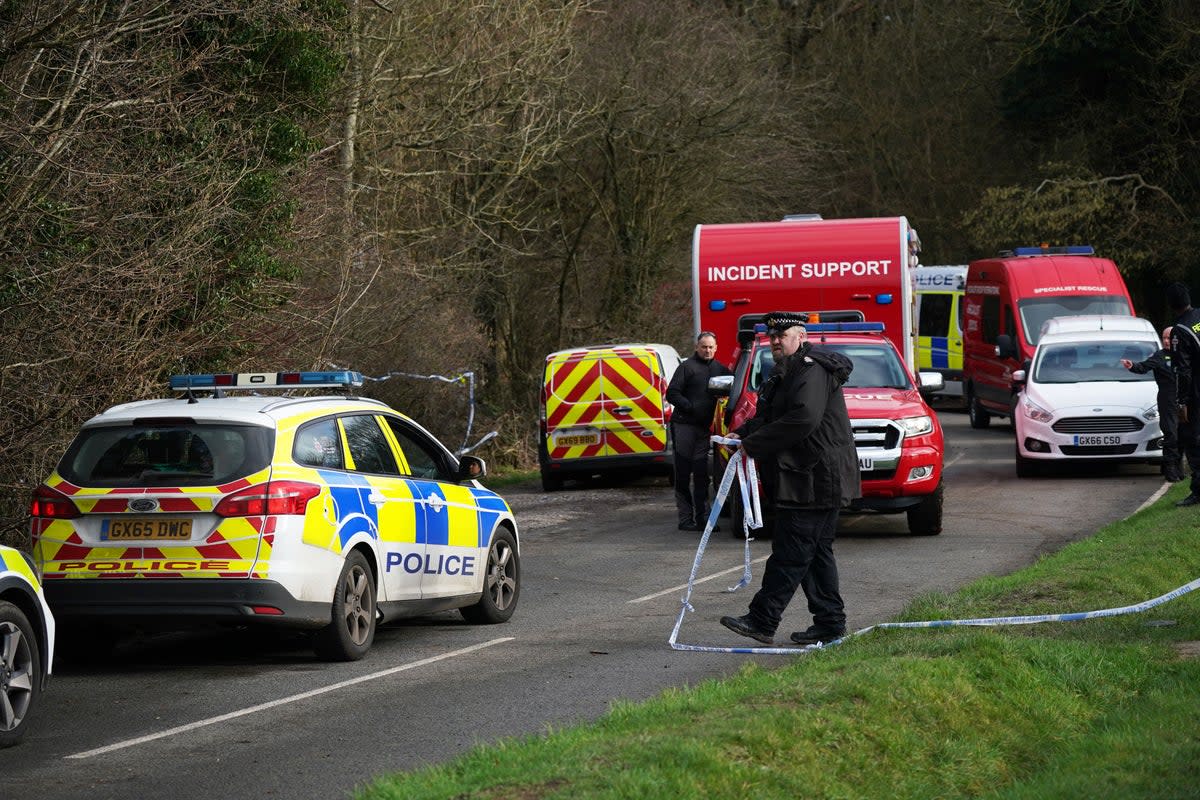 Police at Gravelly Hill in Caterham, Surrey, after a woman was killed   (PA Wire)