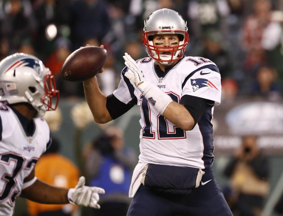 FILE - In this Sunday, Nov. 27, 2016 file photo, New England Patriots quarterback Tom Brady (12) looks to pass to running back Dion Lewis (33) during the first quarter of an NFL football game in East Rutherford, N.J. As New England (10-2) prepares to host the Baltimore Ravens Monday night, Dec. 12, 2016 the ghost of “Deflategate” has emerged this week, even as Brady insists it’s the furthest thing from his mind. (AP Photo/Julio Cortez, File)