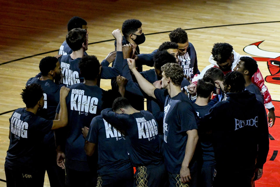 Chicago Bulls players wear shirts that honor Dr. Martin Luther King Jr., before an NBA basketball game against the Houston Rockets, Monday, Jan. 18, 2021, in Chicago. (AP Photo/Matt Marton)