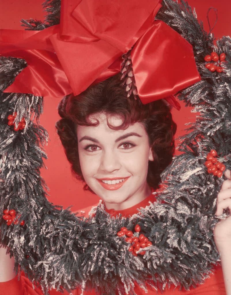 <p>Italian actress Annette Funicello opted for a red turtleneck, as she poses with a decorative wreath in 1955. </p>