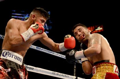 Abner Mares, left, hits Jose Ramirez during Mares' December 2014 win. (Getty)