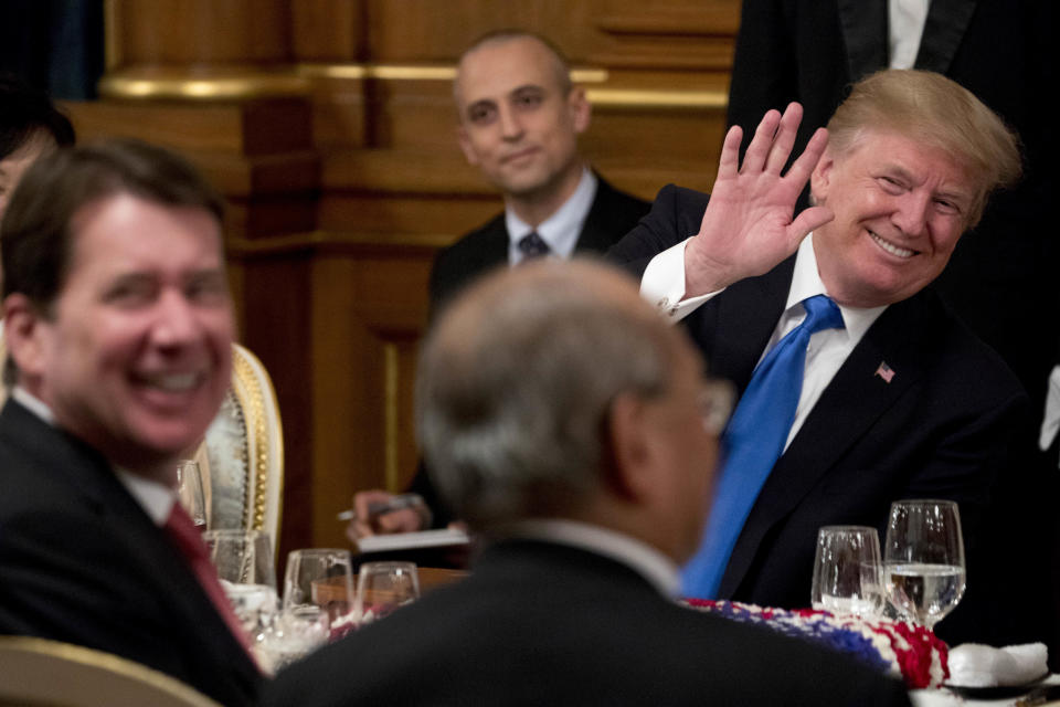 U.S. President Donald Trump, right, accompanied by U.S. Ambassador to Japan William F. Hagerty, left, waves to a guest during a state banquet at the Akasaka Palace, Monday, Nov. 6, 2017, in Tokyo. (AP Photo/Andrew Harnik)