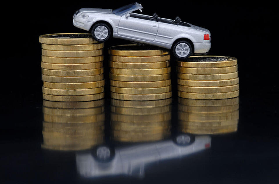 Car sits on top of coins. Source: Getty