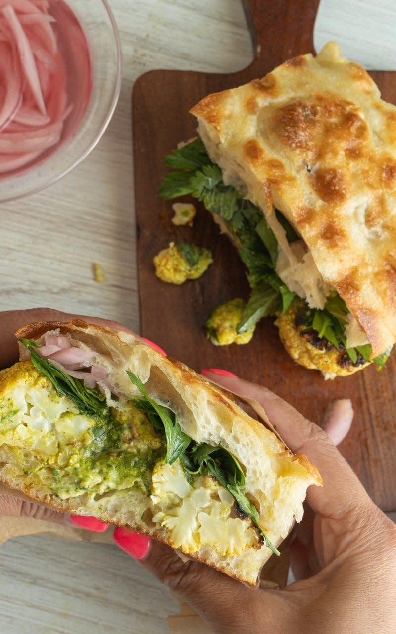 Flour, a new restaurant at S&W Market, offers a spiced cauliflower focaccia sandwich made with tahini, zhoug, pickled onion, herb salad and lime.