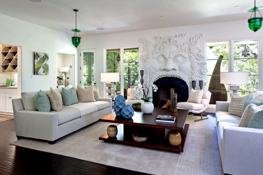 Geena Davis' Pacific Palisades home, full of white walls and soothing hues, opens to a living room with a sculptural fireplace. Listed for $5.995 million, the Mediterranean-style home has five bedrooms, an office and an updated kitchen.