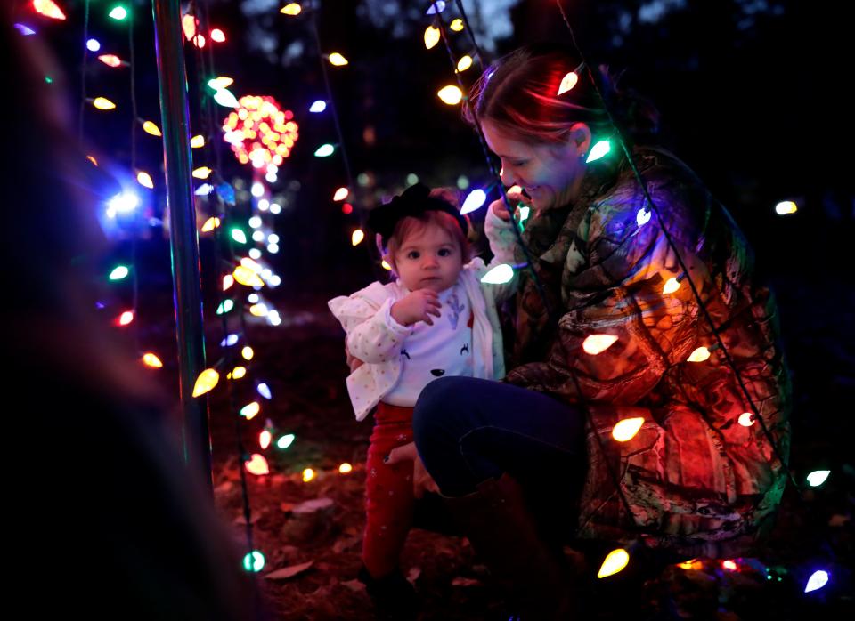 Shannon Depottey holds Emma Douglas, 1, as they pose for a photo during Elf Night at Dorothy B. Oven Park on Thursday, Dec. 19, 2019. 