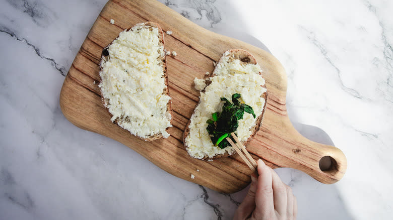 Topping bread slices with spinach