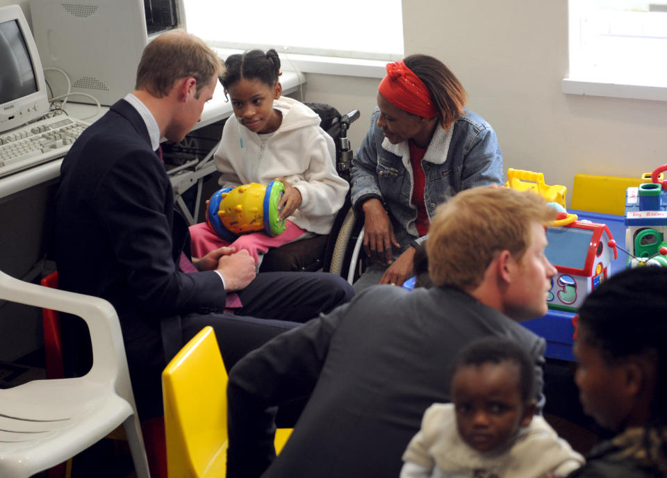 Princes William and Prince Harry play with young patients while visiting the Red Cross War Memorial Hospital in Cape Town, South Africa.