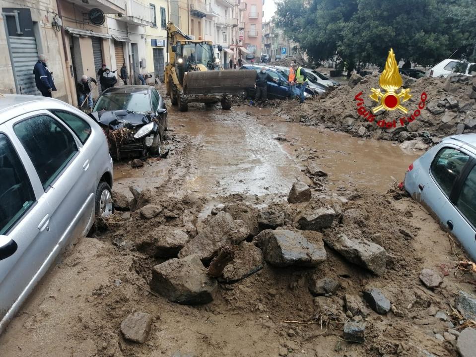 Cars among other debris litter the street in Bitti, Sardinia, Italy, Sunday, Nov. 29, 2020. The town of Bitti in Sardinia was hit by a storm and flooded by a massive mudslide on Saturday. (Vigili del Fuoco via AP)