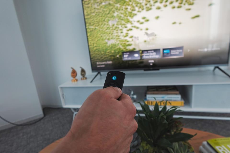 Closeup of Alexa Voice Remote with the Amazon Fire TV Omni QLED Series