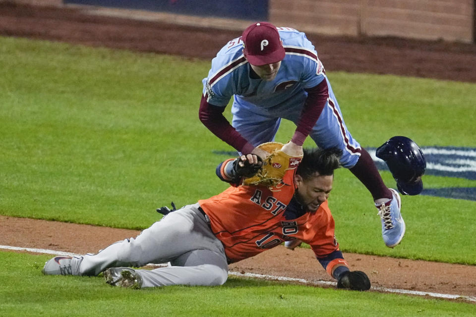 Philadelphia Phillies first baseman Rhys Hoskins tags Houston Astros' Yuli Gurriel in a run down during the seventh inning in Game 5 of baseball's World Series between the Houston Astros and the Philadelphia Phillies on Thursday, Nov. 3, 2022, in Philadelphia. (AP Photo/Matt Rourke)