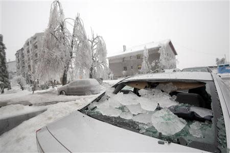 A car with a smashed rear windscreen is seen amid heavy ice in Postojna February 5, 2014. REUTERS/Srdjan Zivulovic
