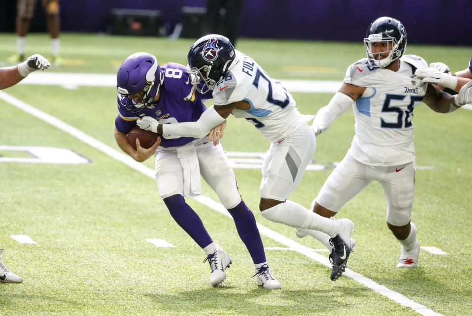 Minnesota Vikings quarterback Kirk Cousins (8) is sacked by Tennessee Titans cornerback Kristian Fulton during the second half of an NFL football game, Sunday, Sept. 27, 2020, in Minneapolis. The Titans won 31-30. (AP Photo/Bruce Kluckhohn)