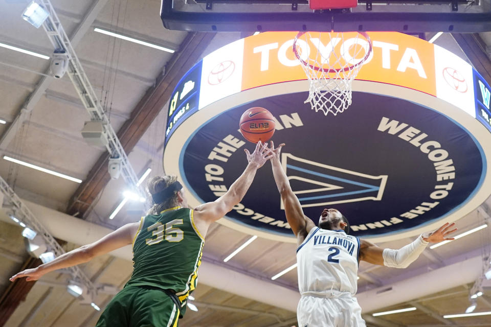 Villanova's Mark Armstrong, right, and Le Moyne's Nate McClure reaches for a rebound during the second half of an NCAA college basketball game, Friday, Nov. 10, 2023, in Villanova, Pa. (AP Photo/Matt Slocum)