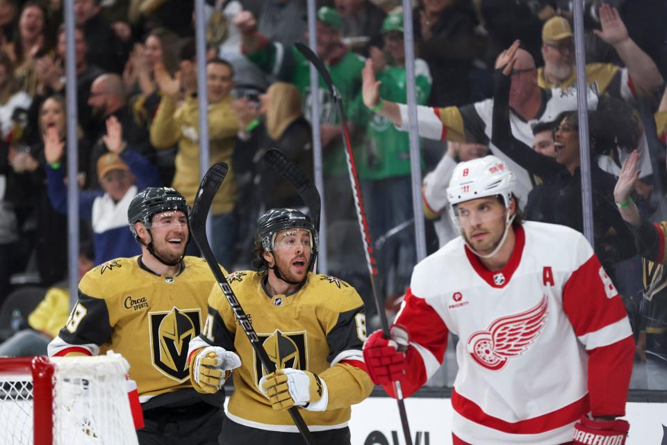 Vegas Golden Knights center Ivan Barbashev (49) and right wing Jonathan Marchessault (81) celebrate a goal while Detroit Red Wings defenseman Ben Chiarot (8) skates for the bench during the first period at T-Mobile Arena in Las Vegas on Saturday, March 9, 2024.