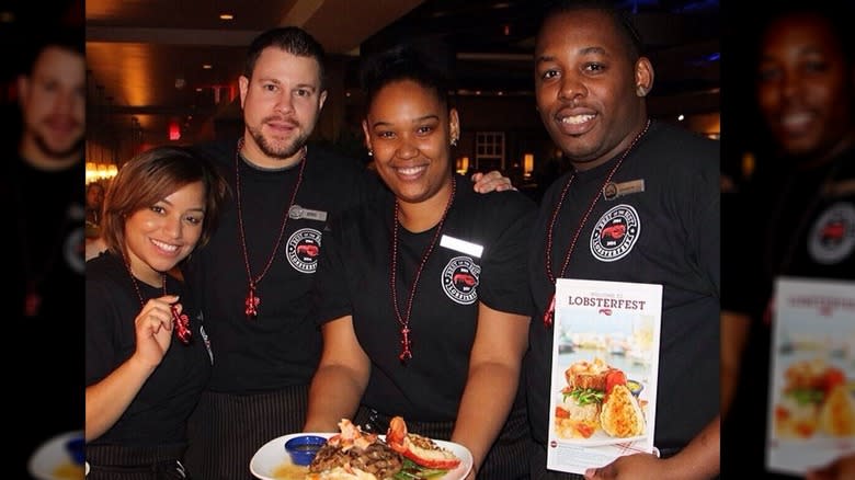 Four employees wearing black t-shirts 