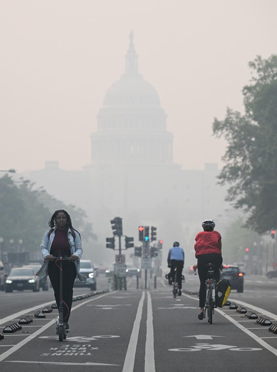 <p>People commute under a blanket of haze partially obscuring the US Capitol in Washington, DC, on June 8, 2023. Smoke from Canadian wildfires have shrouded the US East Coast in a record-breaking smog, forcing cities to issue air pollution warnings and thousands of Canadians to evacuate their homes. The devastating fires have displaced more than 20,000 people and scorched about 3.8 million hectares (9,390,005 acres) of land. Prime Minister Justin Trudeau described this wildfire season as the country's worst ever. (Photo by Mandel NGAN / AFP) (Photo by MANDEL NGAN/AFP via Getty Images)</p> 