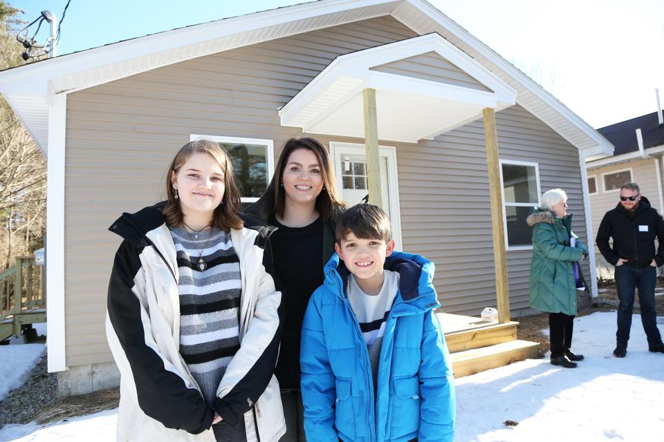 Ashley LaBelle and her two children Avery, 14 and Carter, 9, stand in front of their new Habitat for Humanity York County home in Sanford Feb. 20, 2024.