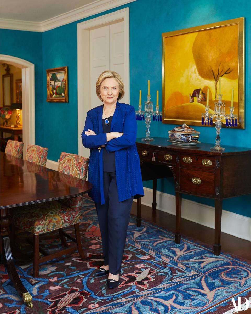 The former Secretary of State stands in her dining room. Behind her is a second painting she and President Clinton brought back from their visit to Vietnam. The candelabras were made in the 1920s by the Heisey Glass Company and still feature the original cobalt drops. Cobalt: clearly another one of Ms. Clinton’s favorite shades.
