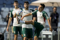 Carlos Rodriguez, front, kicks a ball during Mexico official training on the eve of the group C World Cup soccer match between Argentina and Mexico, in Jor , Qatar, Friday, Nov. 25, 2022. (AP Photo/Moises Castillo)