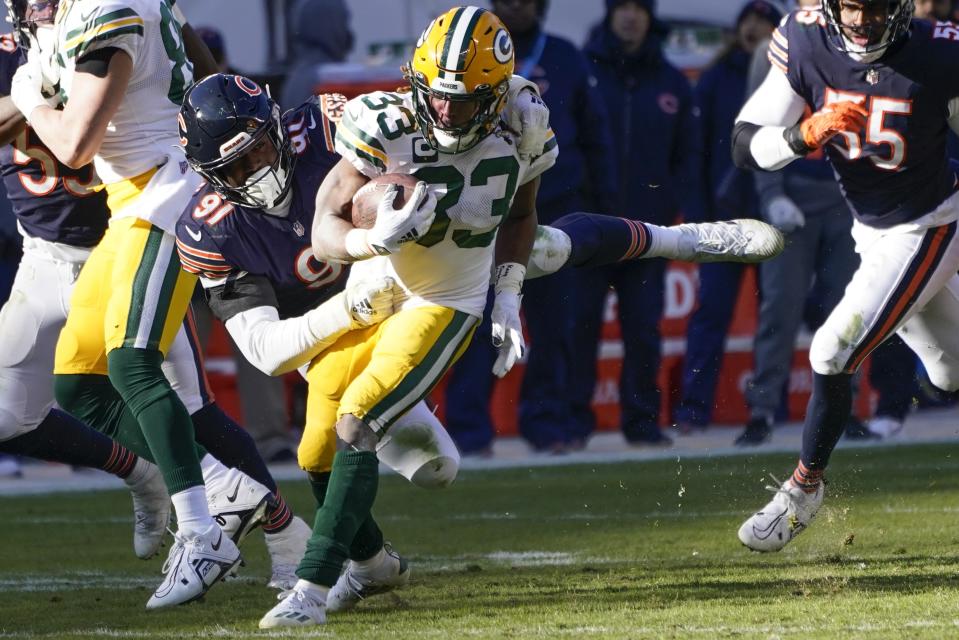 Chicago Bears' Dominique Robinson stops Green Bay Packers' Aaron Jones during the first half of an NFL football game Sunday, Dec. 4, 2022, in Chicago. (AP Photo/Charles Rex Arbogast)
