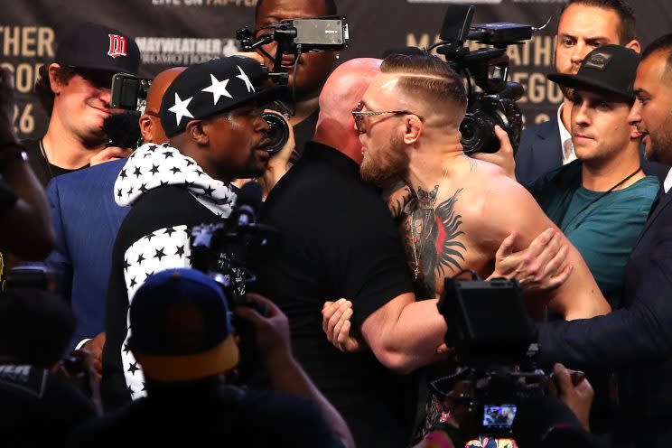 Floyd Mayweather Jr. and Conor McGregor face off during New York stop of their media tour. (Getty)