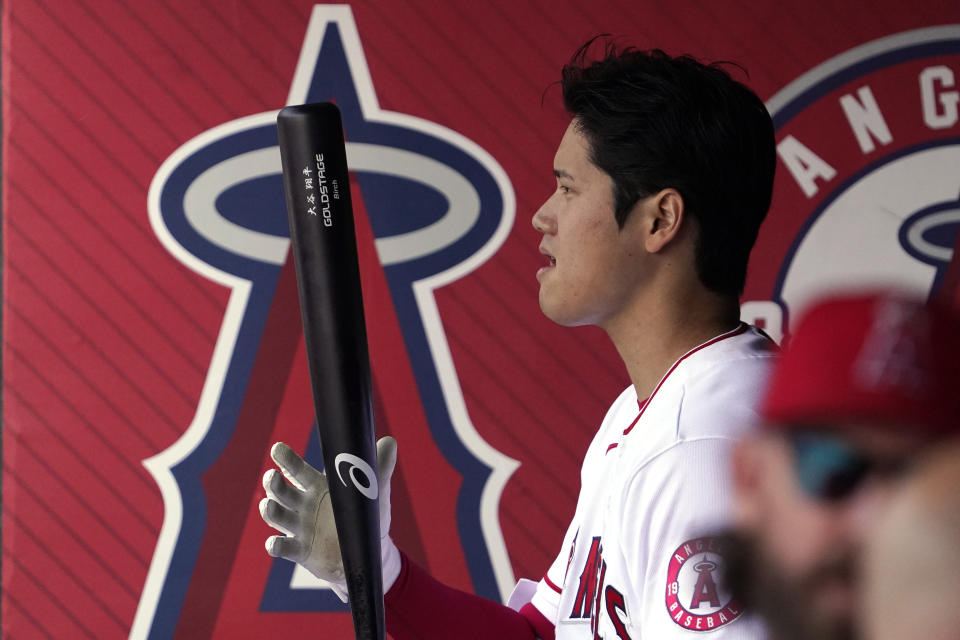Los Angeles Angels' Shohei Ohtani stands in the dugout as he gets ready to bat during the first inning of a baseball game against the Toronto Blue Jays Sunday, May 29, 2022, in Anaheim, Calif. (AP Photo/Mark J. Terrill)