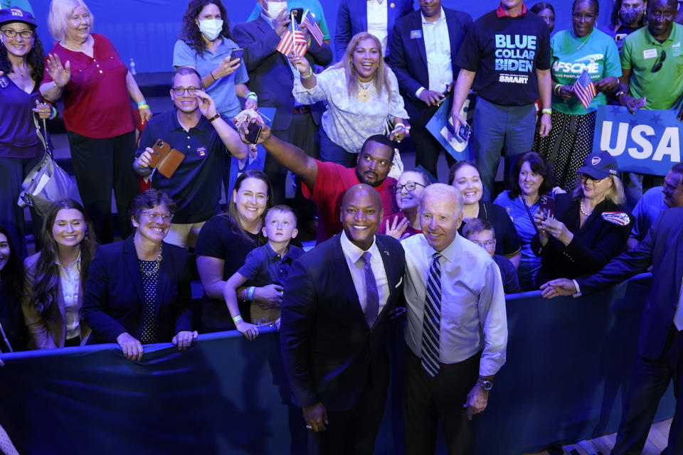 President Joe Biden poses for a photo with Maryland Democratic gubernatorial candidate Wes Moore after speaking at a rally hosted by the Democratic National Committee at Richard Montgomery High School, Thursday, Aug. 25, 2022, in Rockville, Md. (AP Photo/Evan Vucci)