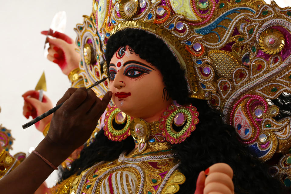 An artisan gives a final touches to an idol of the Goddess Durga ahead of the upcoming 'Durga Puja' festival in Ajmer, in the Indian state of Rajasthan on 9 October 2020. (Photo by Himanshu Sharma/NurPhoto via Getty Images)