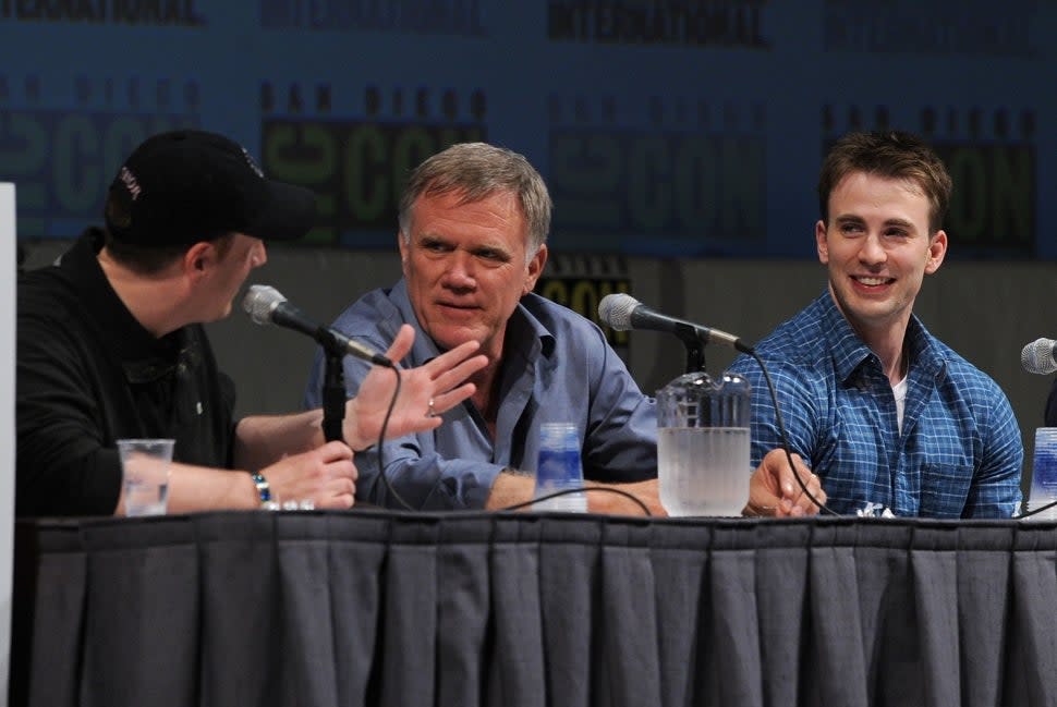 The Rocketeer director Joe Johnston sits next to Kevin Feige and Chris Evans at Comic-Con.